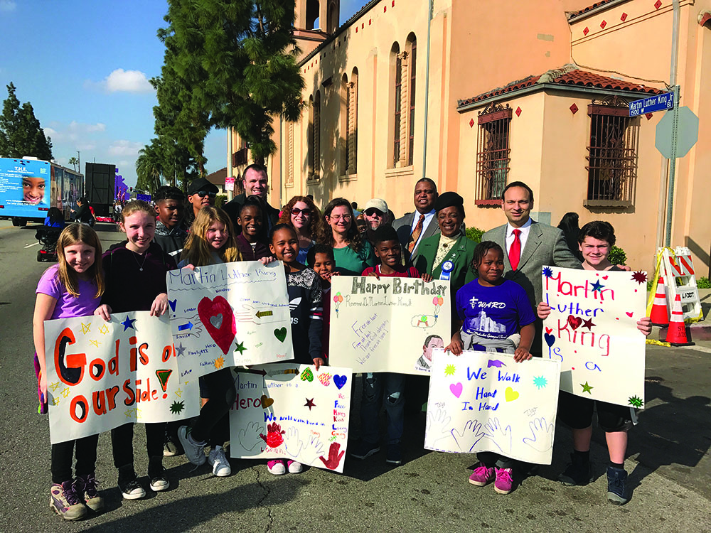 On Martin Luther King Jr. Day, Adat Shalom Jewish Education Center students and Ward African Methodist Episcopal Church youth came together at the 32nd annual Kingdom Day Parade. Adat Shalom Rabbi Nolan Lebovitz (second row, far right) and Ward AME Church Rev. John Edward Cager III (back row, far right) were among the attendees. 