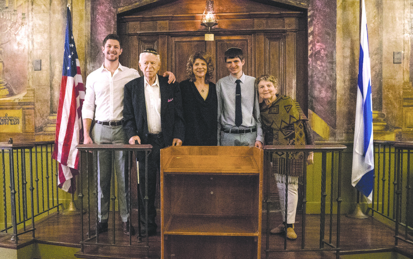 From left: Family members Louis Evans, Ernest Braunstein, Gilda Evans, Loren Evans and Ida Braunstein gather on the bimah at the Boyle Heights synagogue.