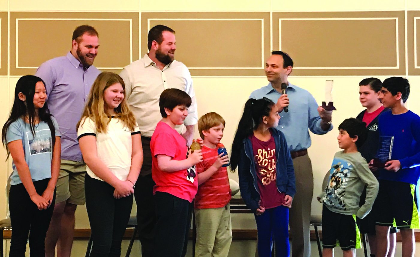 Mitchell and Geoff Schwartz, along with Rabbi Nolan Lebovitz, participate in a recent program at Adat Shalom. The Schwartzes attended religious school and became b’nai mitzvah there. Photo courtesy of Adat Shalom  