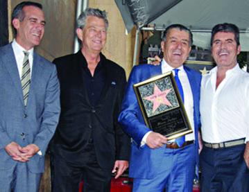 From left: Mayor Eric Garcetti, David Foster, Haim Saban and Simon Cowell come together to celebrate Saban receiving a star on the Hollywood Walk of Fame. Photo courtesy of Hollywood Chamber of Commerce.