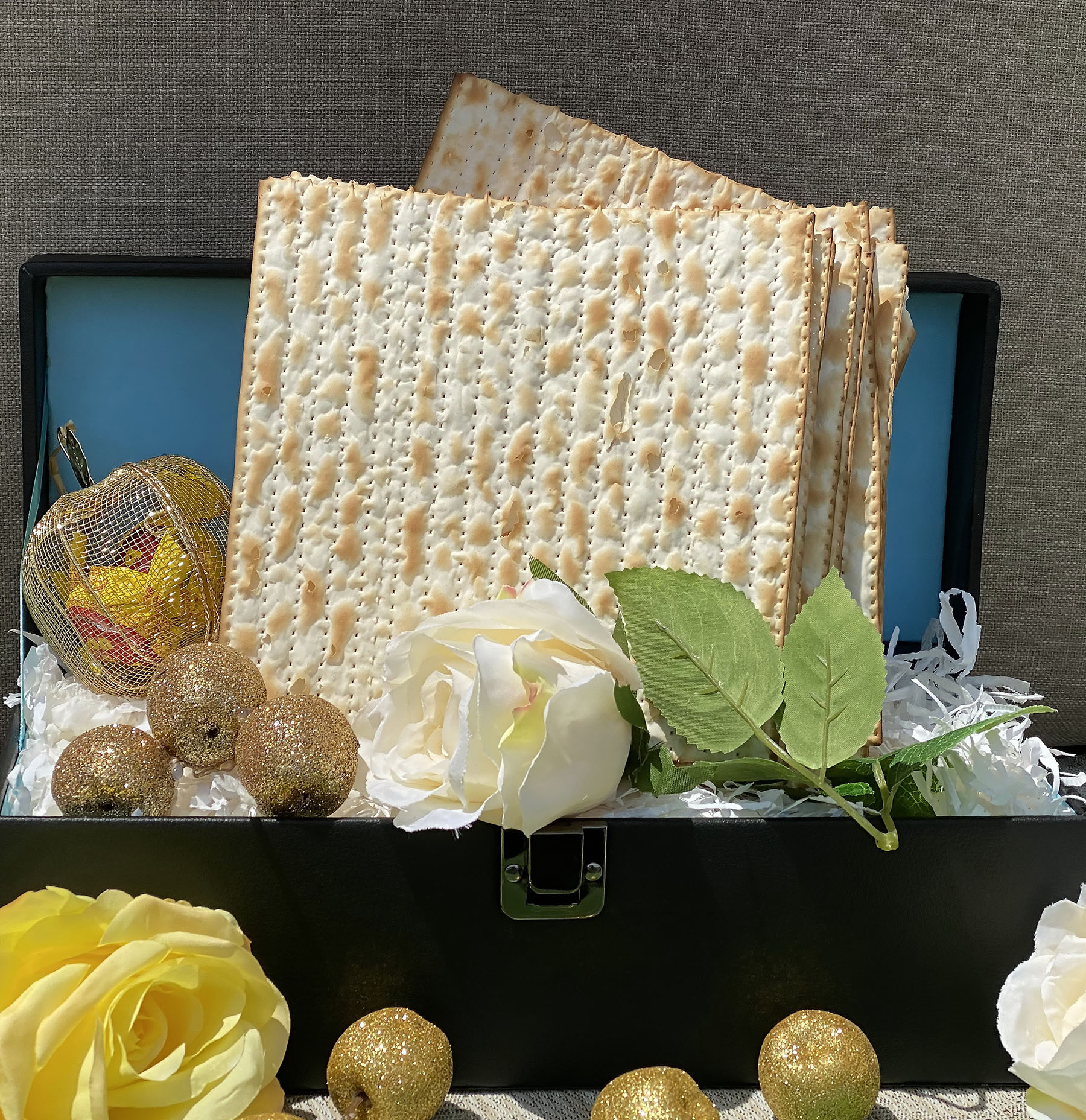 Pesach-Jewish easter. Feast in Passover. Matzah in gift leather chest with souvenir apples and roses