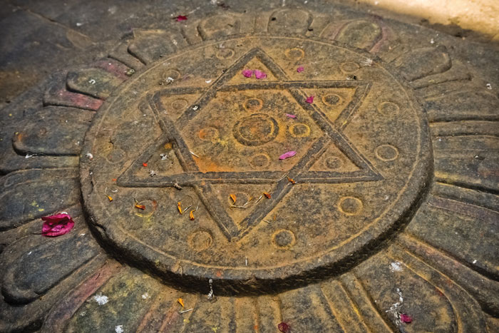 The hexagram of two interlocking triangles represents the male and female force (Shiva and Shakti) in Hindu religion. It is more commonly associated with Judaism as the the Star of David. This carving is set within a lotus in the courtyard of the Royal Kumari of Kathmandu. Cindybug/Getty Images